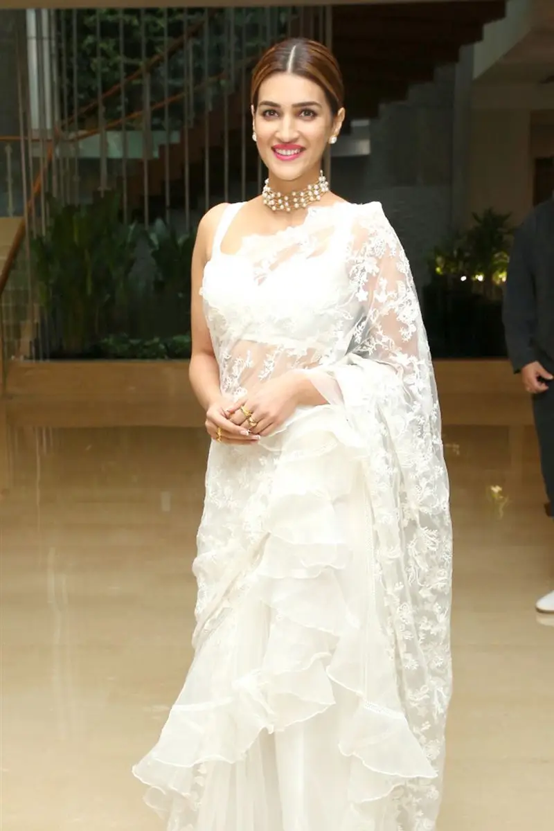 Kriti Sanon Charming Stills In White Saree Sleeveless Blouse